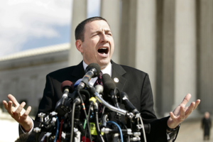Robert Schenck stands in front of a cluster of microphones at the Supreme Court Building in 2005