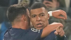 CORRECTS NAME OF PLAYER - PSG's Kylian Mbappe, right, celebrates after scoring his side's opening goal during the Champions League group H soccer match between Juventus and Paris Saint Germain at the Allianz stadium in Turin, Italy, Wednesday, Nov. 2, 2022. (AP Photo/Antonio Calanni)