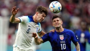 John Stones battles for possession with Christian Pulisic