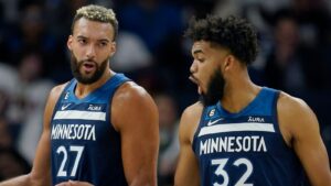 Minnesota Timberwolves center Rudy Gobert, left, and center Karl-Anthony Towns talk during the first half of a clash with the San Antonio Spurs in October 2022